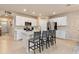 Spacious kitchen featuring an island with seating, white cabinetry, and stainless steel appliances at 3860 Cobblestone Ln, Punta Gorda, FL 33980