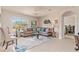 Bright and inviting living room featuring neutral tones, large windows, comfortable seating and tile flooring at 3860 Cobblestone Ln, Punta Gorda, FL 33980