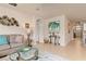 Living room showcasing a comfortable sofa, stylish decor, and tile flooring leading to other parts of the house at 3860 Cobblestone Ln, Punta Gorda, FL 33980