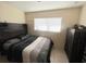 Cozy bedroom featuring tile flooring, natural light, and a contemporary dark wood headboard at 4045 Conway Blvd, Port Charlotte, FL 33952