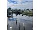 Beautiful canal view featuring multiple boats docked at the water's edge and waterfront homes at 4045 Conway Blvd, Port Charlotte, FL 33952