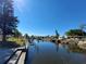 Scenic canal view with waterfront properties and private docks under a clear blue sky at 4045 Conway Blvd, Port Charlotte, FL 33952