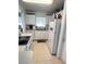 Efficient kitchen featuring white cabinets, appliances, and tile flooring at 4045 Conway Blvd, Port Charlotte, FL 33952