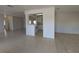 Open-concept living room with tile flooring, a partial wall, and a view of the kitchen at 4045 Conway Blvd, Port Charlotte, FL 33952