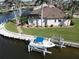 Beautiful waterfront home boasts private boat lift and lush green lawn at 507 Saint Girons Ct, Punta Gorda, FL 33950