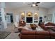 Bright living room with a ceiling fan, built-in entertainment center, and cozy seating arrangement at 507 Saint Girons Ct, Punta Gorda, FL 33950