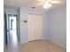 Neutral bedroom with tile floor and double door closet at 5098 Adina Cir, North Port, FL 34291