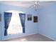 Light blue bedroom with tile flooring and sunny window with valance at 5098 Adina Cir, North Port, FL 34291