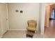Hallway featuring tile floors, light green walls, and an antique-style chair with a matching footstool at 5098 Adina Cir, North Port, FL 34291