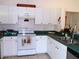 Well-lit kitchen featuring white cabinets, updated countertops, and modern appliances at 5098 Adina Cir, North Port, FL 34291