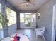 Enclosed porch with tiled floor, ceiling fan, and outdoor views at 5098 Adina Cir, North Port, FL 34291