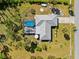 Aerial shot of the house featuring a screened-in pool, patio, and well-manicured lawn at 5126 Richmond Ter, North Port, FL 34287
