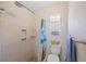This bathroom features a tiled shower with built-in shelving and updated fixtures at 5126 Richmond Ter, North Port, FL 34287