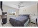 Bright bedroom featuring a large window, wood-look floors, and a stylish ceiling fan at 5126 Richmond Ter, North Port, FL 34287