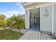 The front entrance welcomes you with beautiful landscaping, wrought iron gate, and a charming blue accent wall at 5126 Richmond Ter, North Port, FL 34287