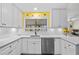 Bright kitchen featuring white cabinets, stainless steel appliances, and stylish backsplash at 5126 Richmond Ter, North Port, FL 34287