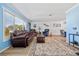 The living room features comfortable seating, laminate flooring, and bright, neutral paint to create a cozy atmosphere at 5126 Richmond Ter, North Port, FL 34287