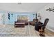 A view of the well decorated living room featuring laminate flooring, comfortable seating, and lots of natural light at 5126 Richmond Ter, North Port, FL 34287