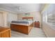 Spacious main bedroom with ceiling fan, closet, and light-filled window at 5126 Richmond Ter, North Port, FL 34287