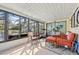 Relaxing sunroom with tile floors, seating, and access to the backyard with views at 5126 Richmond Ter, North Port, FL 34287