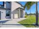 Modern two-story home with a light gray exterior, stone accents, and well-maintained lawn and landscaping at 5636 Barlow Ter, North Port, FL 34287