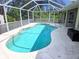 This screened-in pool features a unique shape and ample deck space at 5746 Douglas Rd, North Port, FL 34288