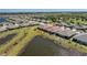 Aerial perspective of a home, showcasing its backyard adjacent to a pond in a neat community at 7304 W Lenox Circle, Punta Gorda, FL 33950