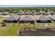 Aerial shot of a backyard facing a pond and serene landscaping in a tidy residential neighborhood at 7304 W Lenox Circle, Punta Gorda, FL 33950