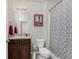 Bathroom featuring a vanity, toilet, and shower with gray patterned curtain at 7304 W Lenox Circle, Punta Gorda, FL 33950