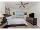 Bedroom featuring a ceiling fan, neutral carpeting, dresser, and ample natural light at 7304 W Lenox Circle, Punta Gorda, FL 33950