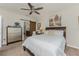 Bedroom with neutral carpeting, ceiling fan, ensuite bathroom, and barn-style sliding door at 7304 W Lenox Circle, Punta Gorda, FL 33950