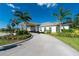 Inviting entrance to the Waterford clubhouse with covered walkway and lush landscaping at 7304 W Lenox Circle, Punta Gorda, FL 33950