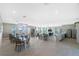Spacious clubhouse interior with multiple tables, a kitchen area, and a cozy seating area at 7304 W Lenox Circle, Punta Gorda, FL 33950