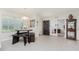 Bright dining area with a modern pendant light, a dark table with benches, and a view of the home's entry at 7304 W Lenox Circle, Punta Gorda, FL 33950