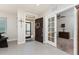 Bright foyer with tile flooring, an open entry door, and a view of a study with glass paneled doors at 7304 W Lenox Circle, Punta Gorda, FL 33950