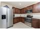 Kitchen featuring stainless steel appliances, dark cabinets, and modern fixtures at 7304 W Lenox Circle, Punta Gorda, FL 33950