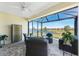 Relaxing screened-in lanai with comfortable seating and picturesque lake views at 7304 W Lenox Circle, Punta Gorda, FL 33950