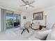 Relaxing living room with tile floors, comfortable seating, and sliding doors to a screened-in porch at 7304 W Lenox Circle, Punta Gorda, FL 33950