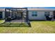 A view of the screened-in patio with outdoor furniture and access to the home's interior at 7304 W Lenox Circle, Punta Gorda, FL 33950