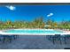 Beautiful pool area, featuring lounge chairs and lush trees around the deck for the perfect relaxation spot at 7304 W Lenox Circle, Punta Gorda, FL 33950
