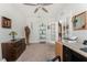 Comfortable study with carpet flooring, a ceiling fan, and a glass-paneled door leading to another area at 7304 W Lenox Circle, Punta Gorda, FL 33950