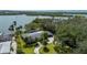 Waterfront property featuring manicured lawns, a screened pool, lush palm trees, and direct waterway access at 75 Spyglass Aly, Placida, FL 33946
