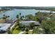 A stunning aerial view of the property, showcasing lush landscaping, boat dock and waterfront access at 75 Spyglass Aly, Placida, FL 33946