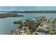 Waterfront home with lush landscaping and scenic bay views from above, showcasing coastal living at its finest at 75 Spyglass Aly, Placida, FL 33946