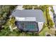 Aerial view of the roof, screened-in pool, and patio of this meticulously landscaped home at 75 Spyglass Aly, Placida, FL 33946