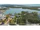 Aerial view of waterfront property showcasing lush surroundings, mature trees, and waterfront views of the bay at 75 Spyglass Aly, Placida, FL 33946