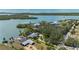 Aerial of waterfront property, boasting lush greenery, privacy, and stunning views of the serene open water at 75 Spyglass Aly, Placida, FL 33946