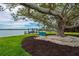 Backyard featuring a mature shade tree with lounging and waterfront views at 75 Spyglass Aly, Placida, FL 33946