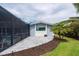 Back patio leads to fenced in pool area with landscaping at 75 Spyglass Aly, Placida, FL 33946