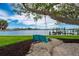 Backyard featuring a beautiful, mature shade tree with a waterside swing at 75 Spyglass Aly, Placida, FL 33946